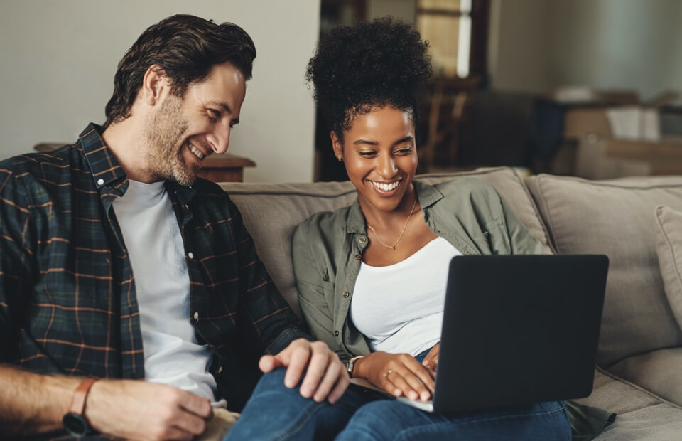 promo image for couple looking at online banking on a laptop